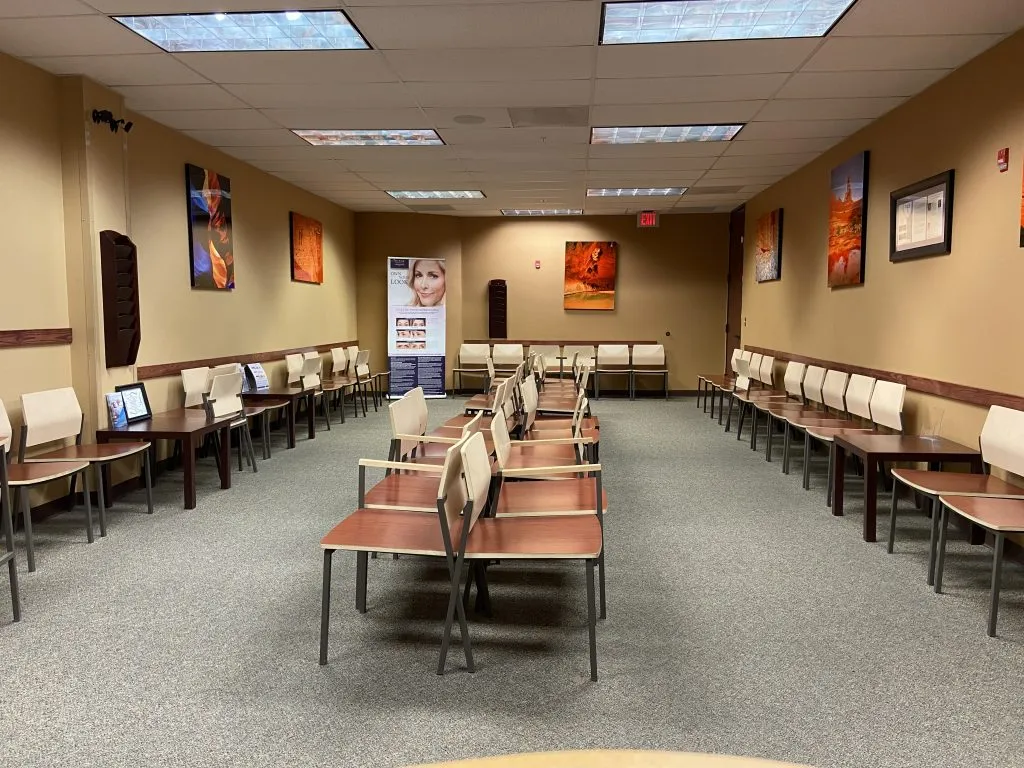 Spacious waiting room at High Desert Oral & Facial Surgery with multiple rows of chairs and wall art