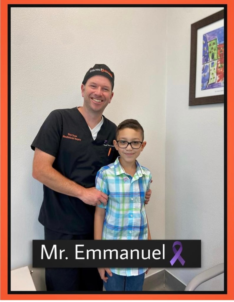 Dr. David Yates poses with a smiling pediatric patient